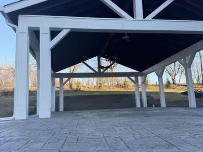 Underside view of outdoor pavilion with chandelier and trusses