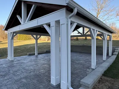 Side view of large white pavilion over patio