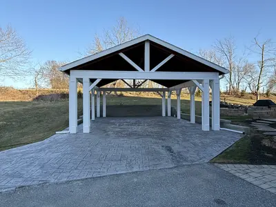 Front view of white pavilion over stamped concrete patio