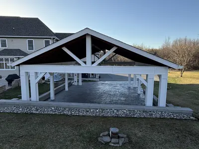 Pavilion next to home with fire pit foreground