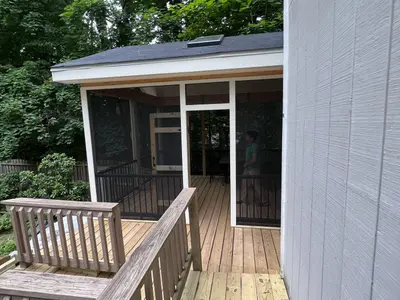Wood deck with screened porch addition and railing
