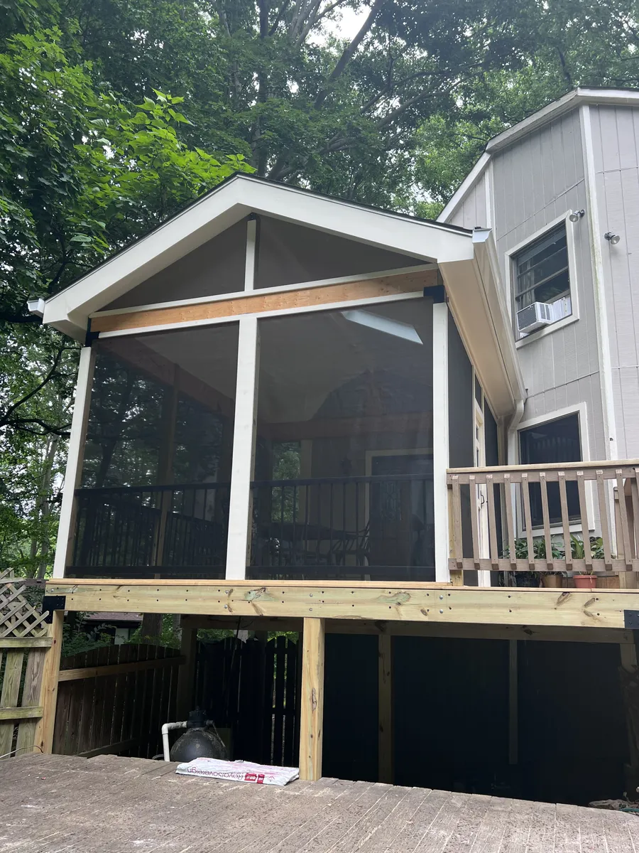 Two-story screened porch addition on gray house
