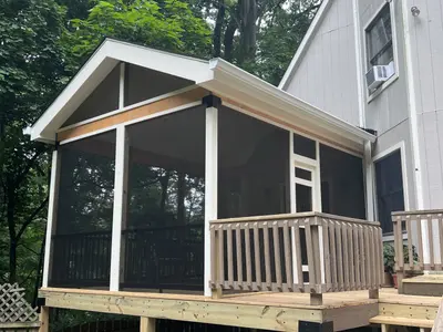 Screened porch addition with wood deck and railings