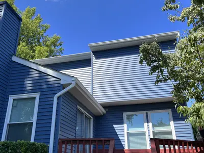 rear addition with blue siding and white trim