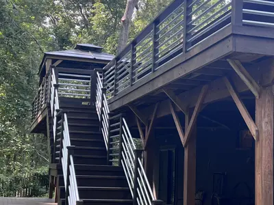 Elevated dark wood deck with stairs and posts