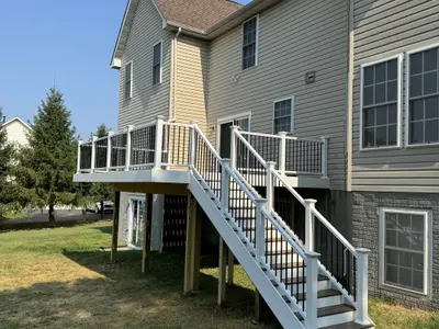 Two-tone elevated deck with white railings and stairs