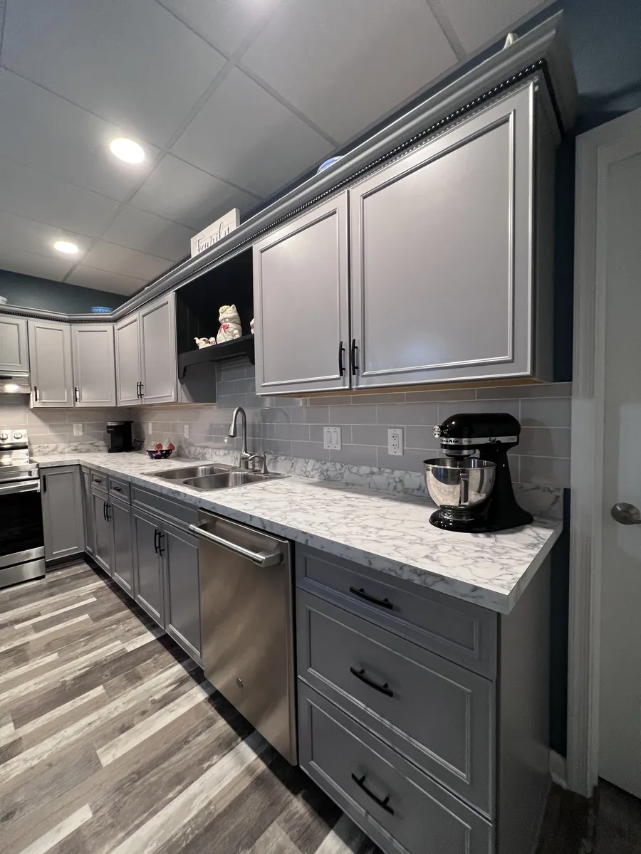 Basement counter with stand mixer and gray cabinets