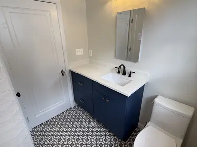 navy vanity white counter patterned tile floor