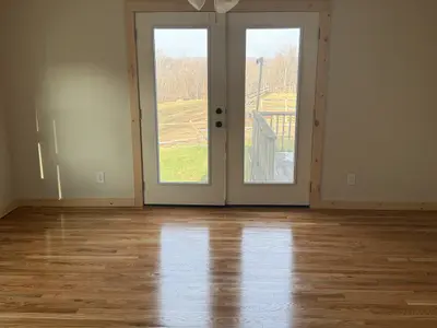 empty room with hardwood floor and french doors