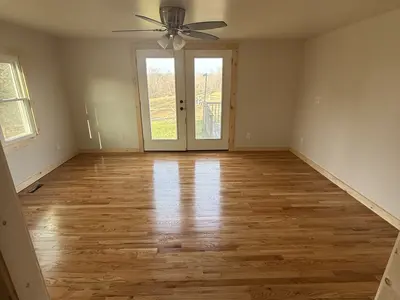 empty room with ceiling fan and french doors