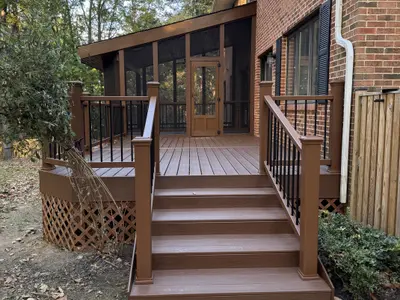 brown composite deck with stairs and screened porch