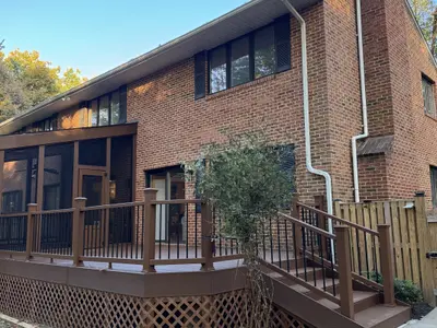 brick house exterior with composite deck and railings