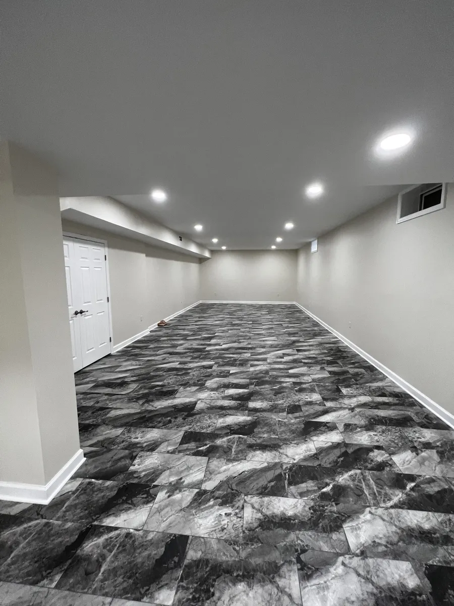 Finished basement with marbled vinyl tile flooring