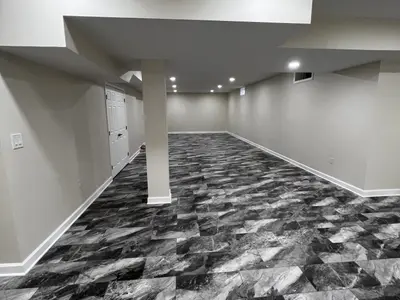 finished basement with column and patterned floor