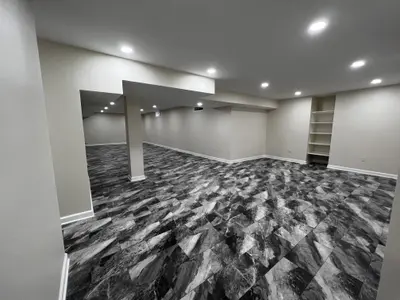 finished basement with column and shelving niche