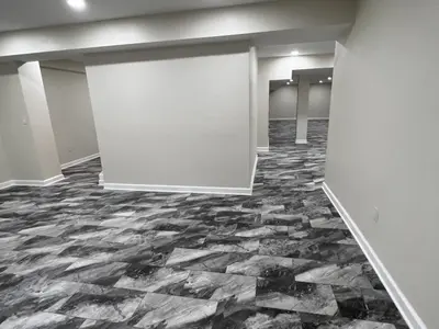finished basement with column and tiled floor