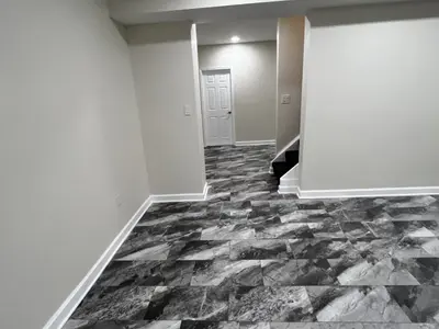 finished basement with stairs and tiled flooring