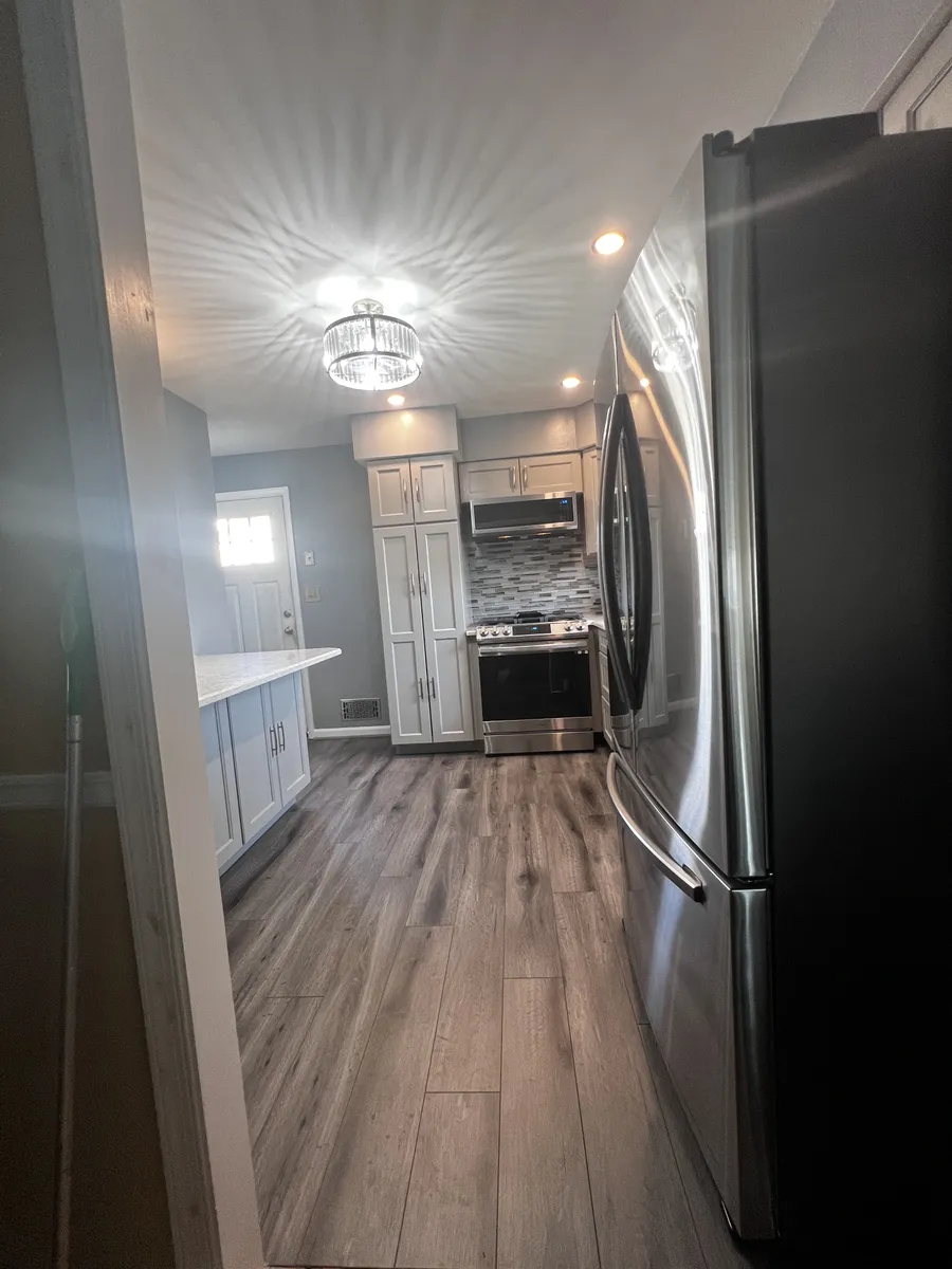 Kitchen remodel with gray cabinets and tile backsplash