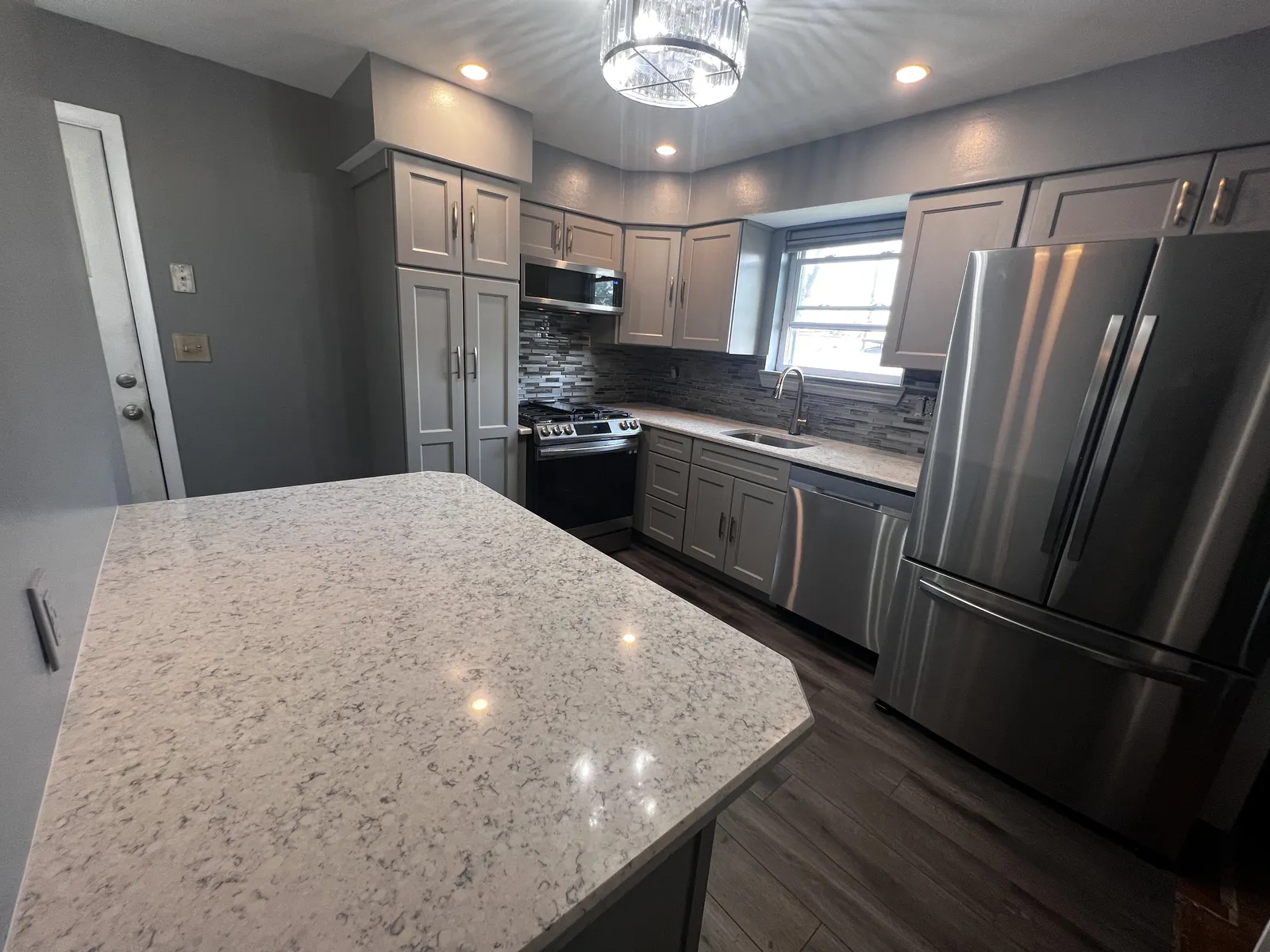 Kitchen island with light stone countertop