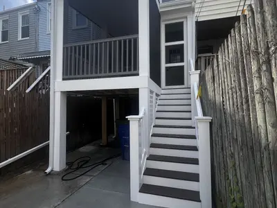 Side view of raised deck with white staircase
