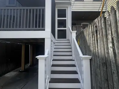 White exterior staircase leading to deck