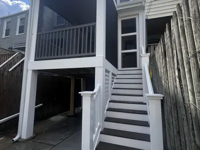 Raised deck and stair structure between row houses