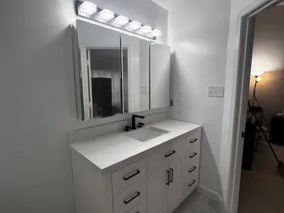 White vanity with mirror and Hollywood lights